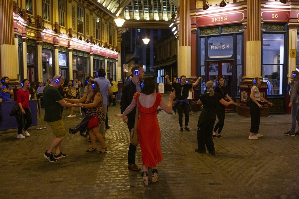 People dancing in Leadenhall market at a silent disco.